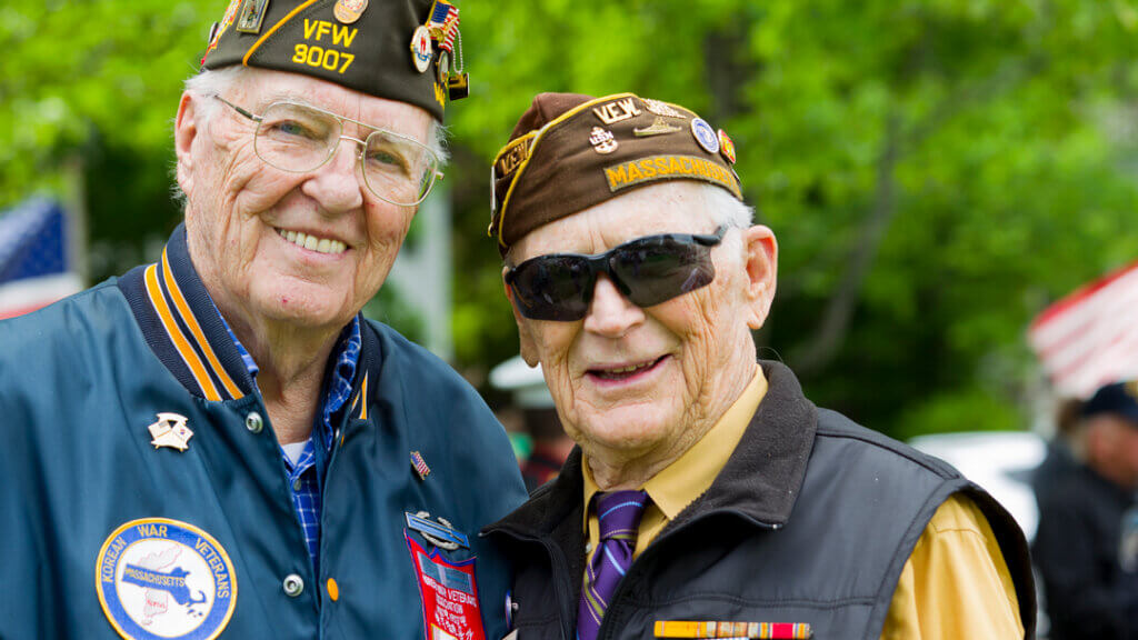 Two senior male military veterans at reunion