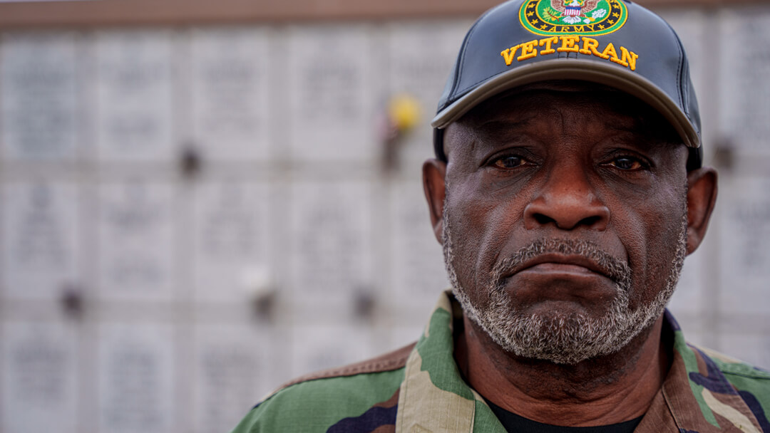 Stern male veteran wearing United States Veteran ball cap